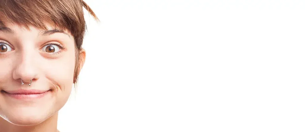 Smiling person with a septum piercing.