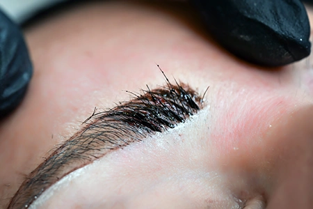 Eyebrow during microblading process.